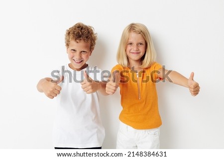 picture of positive boy and girl fun gestures with hands emotions childhood light background