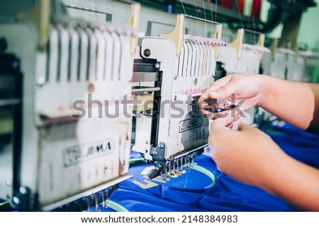 A modern and fully automated high-tech sewing factory for industrial textile or garment manufacturing is closed. Computer embroidery. Royalty-Free Stock Photo #2148384983