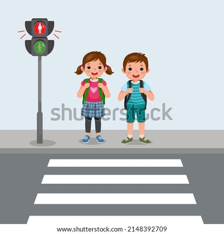 Cute School kids with backpack waiting stop sign on pedestrian traffic light to cross road on zebra crossing on way to school