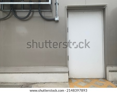 Industrial doors White work. White on the metal wall