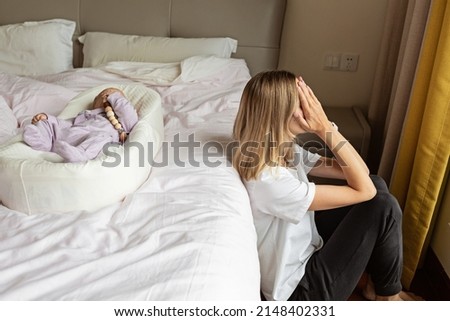 Tired Mother Suffering from experiencing postnatal depression. Health care mom motherhood stressful. Stay home during coronavirus covid-19 pandemic quarantine Royalty-Free Stock Photo #2148402331