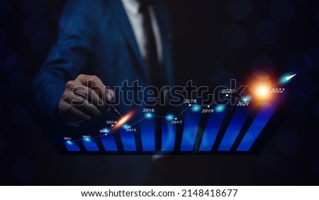 Trader holding digital graph on technology visual screen for trading online stock market forex or stock exchange