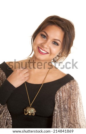 a woman with a smile on her face, wearing a necklace with an elephant on it.