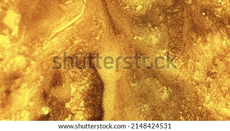 Glitter paint flow. Molten gold texture. Floating ink. Defocused yellow bronze color sparkling fluid leak abstract art background. Royalty-Free Stock Photo #2148424531