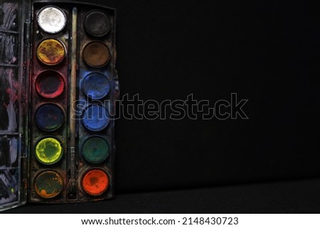 Watercolor palette isolated on black

