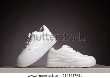 white sneakers. fashion shoes still life. gumshoes. stylish photo in the studio.