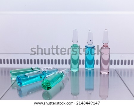 A set of health and beauty injections in ampoules, liquids of different colors in glass ampoules.