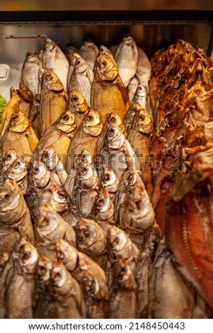 Fish shop: close-up of smoked and dried fish laid out in a shop window. 