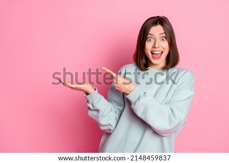Photo of young excited girl indicate finger product offer discount select isolated over pink color background Royalty-Free Stock Photo #2148459837