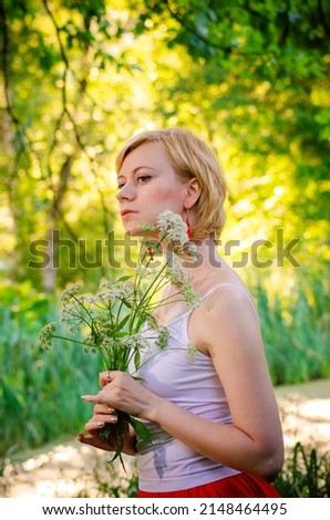 Portrait of a young girl walking in a beautiful summer park. Spring mood. Copy space.