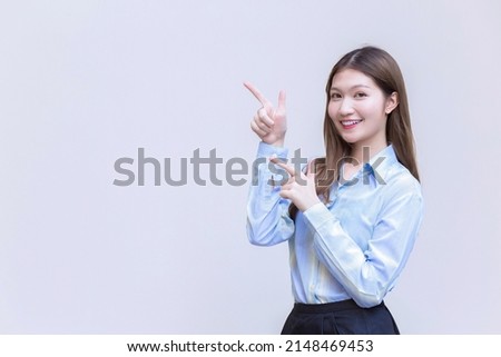 Asian professional business woman  who has long hair with a blue shirt smiles  present something on a white background.