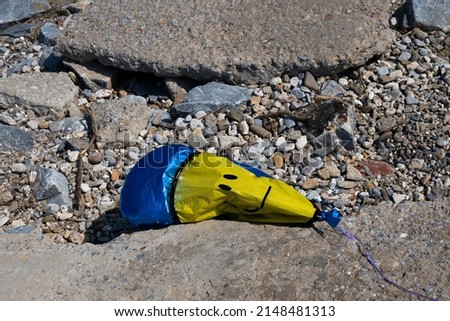 flying balloon lying on the ground in an exploded state
