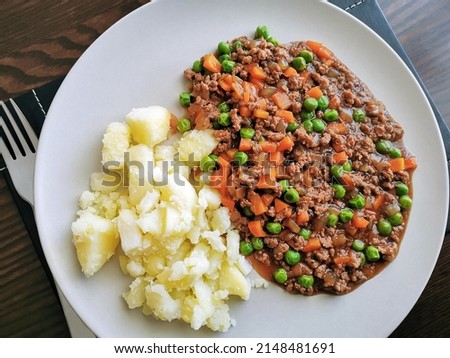 Mince and tatties with a fork on a plate. Traditional Scottish food. Popular dish in Scotland. 