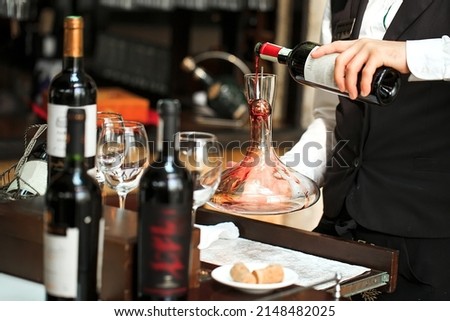 The sommelier is decanting wine in the restaurant Royalty-Free Stock Photo #2148482025