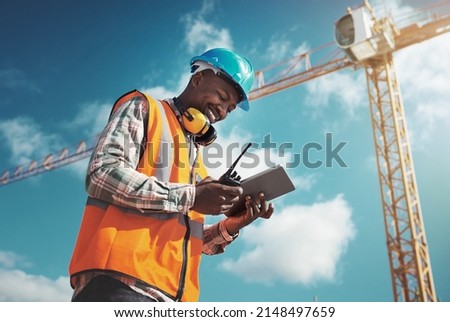 New age tech for new age construction. Shot of a young man using a digital tablet while working at a construction site.