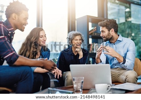 Theyre always performing at their best. Cropped shot of a group of creatives having a meeting in a modern office. Royalty-Free Stock Photo #2148498141