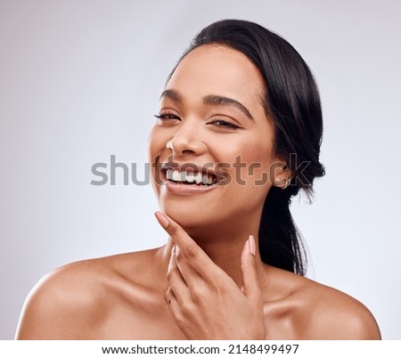 Choose products that support your wellness and make you feel gorgeous. Studio portrait of a beautiful young woman posing against a grey background. Royalty-Free Stock Photo #2148499497