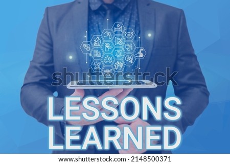 Text sign showing Lessons Learned. Concept meaning Promote share and use knowledge derived from experience Man holding Screen Of Mobile Phone Showing The Futuristic Technology.