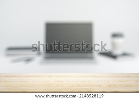 Empty office wooden desktop with empty space on modern workplace with laptop background, closeup, mock up