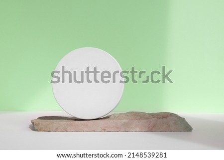 Podium for cosmetic product presentation. Abstract minimal geometrical form with natural Stone. Cylinder podium sphere, geometric circle shape, soft shadow. Scene, showcase, display. Front view.