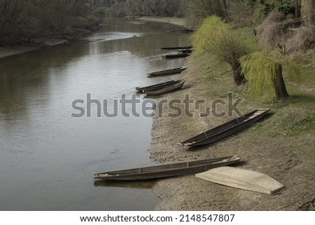 Traditional Alsatian wooden fishing boats at the mouth of River Sauer into River Rhine, sunny spring day (horizontal), Munchhausen, Grand Est, France