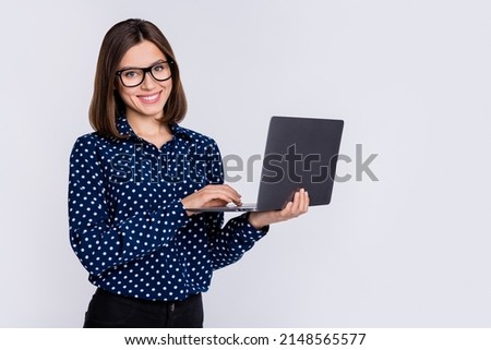 Portrait of attractive trendy cheerful skilled girl using laptop typing report isolated over gray pastel color background