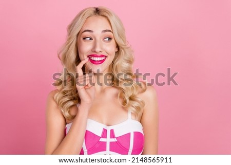 Photo of positive interested coquette lady look empty space wear fancy striped dress isolated pink color background