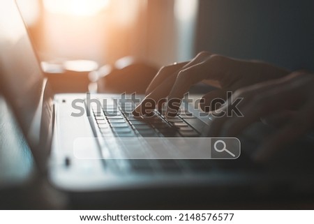  People hand using laptop or computor searching for information in internet online society web with search box icon and copyspace.