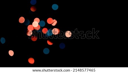 Texture of festive colorful lights garlands are on the black background.Christmas or new year card with bright bokeh lights for magic night winter concept. Time of miracles. Celebration mood