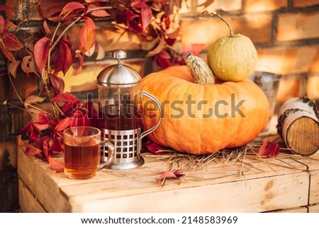 Cup of hot tea, pumpkins, flowers, autumn leaves on wooden table background. Autumn cozy still life. fall season. thanksgiving, mabon, halloween holiday concept. Copy space Royalty-Free Stock Photo #2148583969