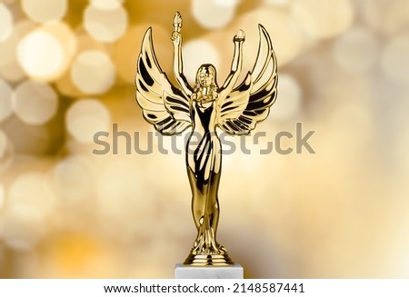 Hollywood Golden Academy award statue on fireworks background. Success and victory concept.