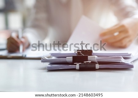 Business Documents, Auditor businesswoman checking searching document legal prepare paperwork or report for analysis TAX time,accountant Documents data contract partner deal in workplace office Royalty-Free Stock Photo #2148603495