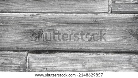The texture of the old tree, the timber from which the house was built. Deep cracks are visible on the wooden beams. High resolution backgrounds and patterns.