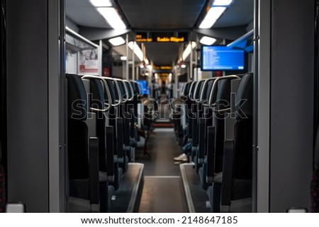 Inside Train. Empty train interior. interior view of the corridor inside passenger trains with dark fabric seats.