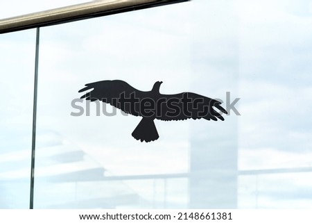 Anti collision black bird shape silhouette glass window sticker on a bridge object detail, closeup, nobody. Birds infrastructure building protection concept, no people