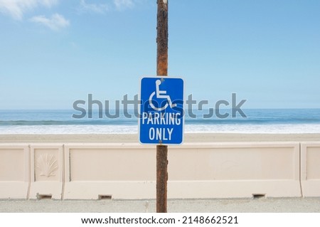 Handicap parking sign in Zuma beach parking lot Malibu California