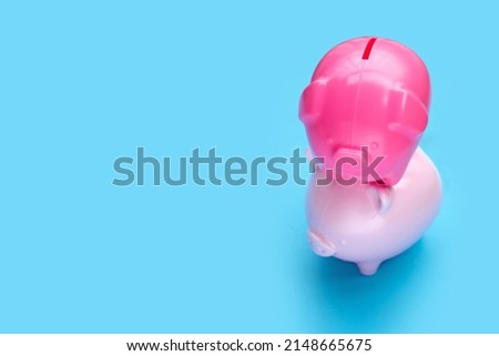 Pink piggy bank on blue background.