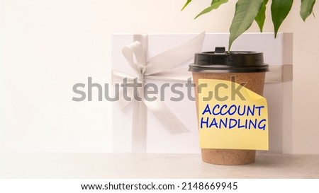 A handwritten note on a disposable coffee cup. ACCOUNT HANDLING