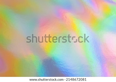Holographic foil texture, abstract colorful trendy background. Shiny backdrop