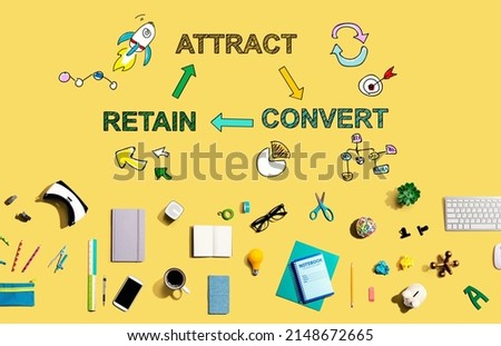 Attract convert retain concept with collection of electronic gadgets and office supplies