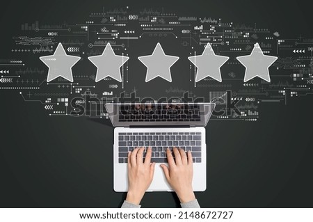 Rating star concept with person using a laptop computer