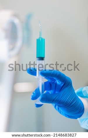 Curved Tip Style Utility Syringes, dental office equipment hand on post injection plastic oral syringes with curved tips dental barrier film protection dental office equipment dental unit  Royalty-Free Stock Photo #2148683827