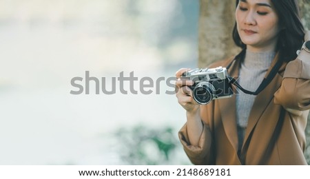 banner of a woman holding a camera travel, portrait of photography, holiday concept. 