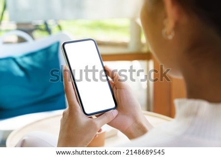 A women holding phone showing white screen