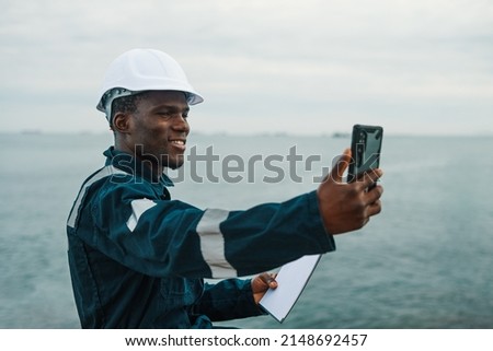 Bosun or seaman officer is taking selfie on the mobile cell phone