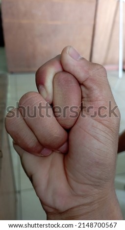 photo of hands that form a unique symbol