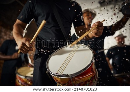 Feeling the rhythm in the drums. Closeup shot of a musical performer playing drums with his band. Royalty-Free Stock Photo #2148701823