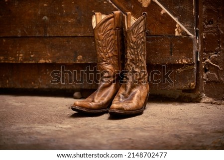 The only footwear for a cowboy. Shot of a pair of cowboy boots. Royalty-Free Stock Photo #2148702477