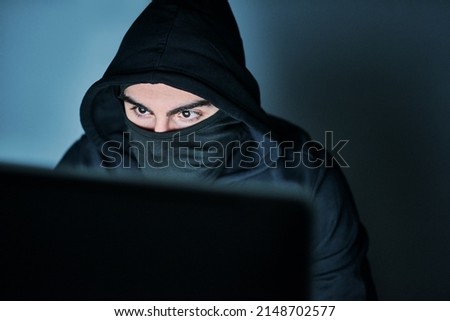 Hes on the hunt for your passwords. Shot of a young hacker using a computer late at night.