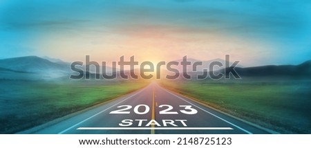 New start of the new year 2023.  Starting to new year.  2023 written on the road in the middle of asphalt road at sunset. Goals,plan,opportunity and new business or life beginning for the next year. Royalty-Free Stock Photo #2148725123